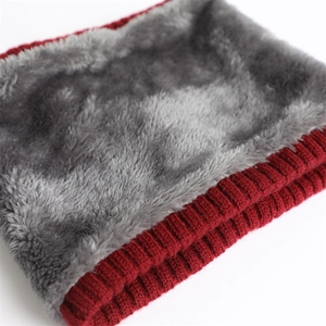 Close-up of red ribbed knit fabric with soft grey faux fur lining for winter warmth