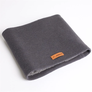Détail d'un tour de cou en tricot gris foncé avec doublure polaire et patch en cuir
