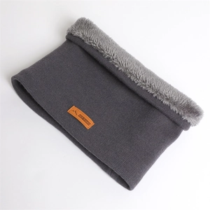 Détail du cache-col en tricot gris avec doublure polaire et écusson en cuir montagne