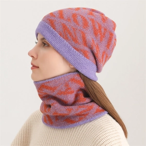Close-up of women's purple knitted beanie and neck warmer with orange pattern