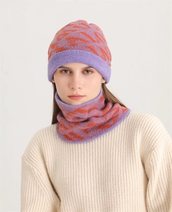 Detail of purple and orange geometric knit beanie hat and matching neck warmer set