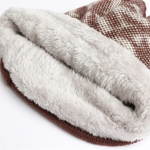 Detailed view of the thick white fleece lining and jacquard knit fabric for winter warmth
