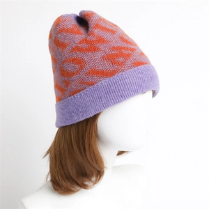Detail of the chunky knit pattern and purple-orange contrast on the warm winter beanie