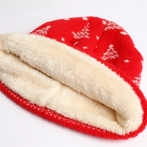 Detailed close-up of the thick faux shearling lining inside the red winter knit hat