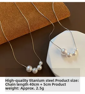 Detail view of pearl necklace in titanium steel showing length and material specs