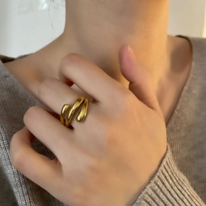 Modern liquid metal wrap ring in polished gold finish on index finger for women