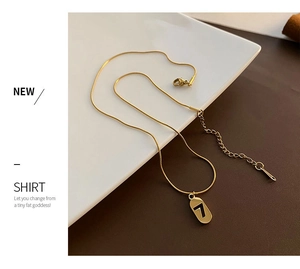 Detailed view of gold titanium lucky number 7 pendant with sleek snake bone chain necklace