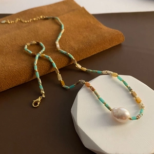 Handmade baroque pearl necklace with colorful stone beads and golden metal accents