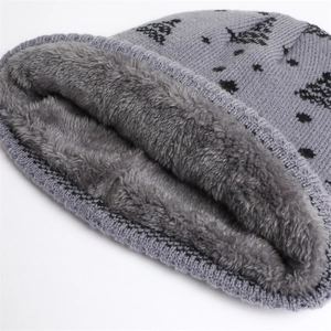 Detail view of winter knit beanie showing thick grey plush fleece lining and tree pattern