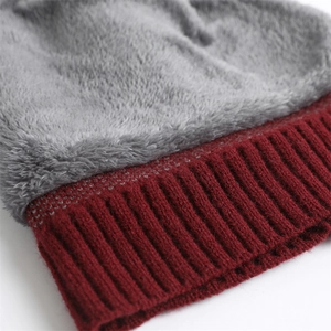 Detail of burgundy ribbed knit exterior and thick grey fleece lining for thermal warmth