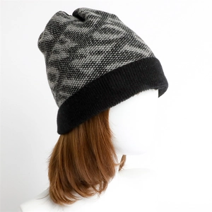 Knitted winter beanie with dark gray geometric jacquard pattern and black ribbed cuff