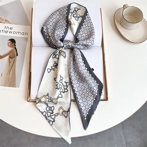 Detail of printed silk-like twilly scarf with chain pattern on a fashion magazine