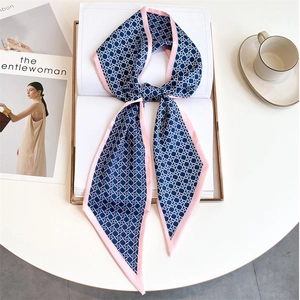 Close-up of geometric pattern silk scarf styled with a coffee cup and magazine