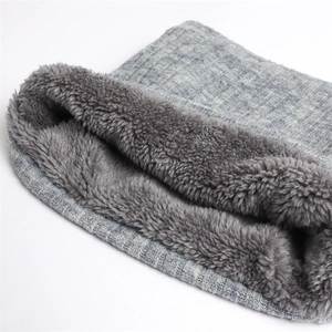 Detail of winter neck warmer showing thick faux fur lining and grey knitted texture