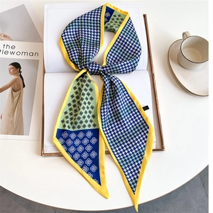 Floral houndstooth silk scarf with yellow border displayed on fashion magazines