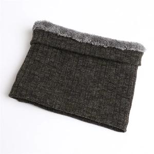 Detail of winter neck warmer showing grey knit texture and thick fleece lining