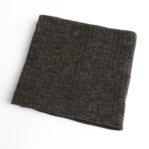 Detail of dark grey winter neck warmer featuring thick ribbed knit texture and soft fabric