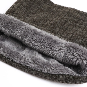 Macro view of brown ribbed knit winter neck warmer with thick grey fleece lining