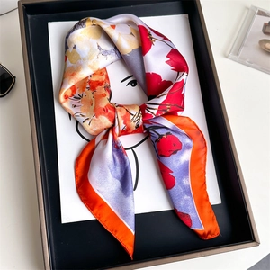 Artistic presentation of a floral silk scarf styled on a portrait sketch card