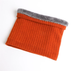Close-up of orange knitted neck warmer with thick grey fleece lining for winter warmth