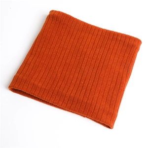 Detail view of the ribbed knit texture on a warm orange winter neck warmer scarf