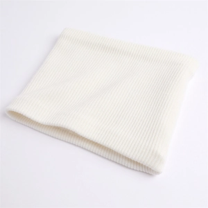 Detail of soft cream white knitted neck warmer showing vertical ribbed texture and yarn