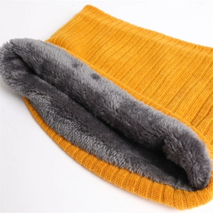 Detail of yellow ribbed knit scarf with thick grey plush fleece lining for winter warmth
