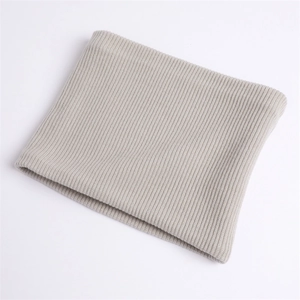 Detail of light gray knitted neck warmer showing thick vertical ribbed texture and elasticity