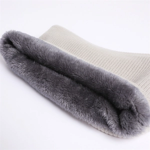 Close-up of cream knit texture and thick grey faux fur lining on winter neck warmer