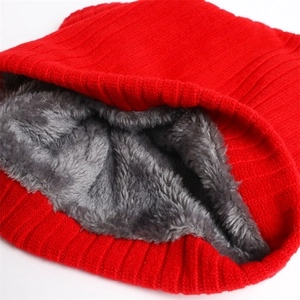 Macro shot of thick red rib-knit fabric with dense grey faux fur lining for winter warmth