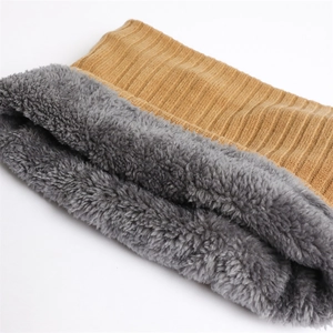 Detail of mustard yellow ribbed knit neck warmer with thick grey faux sherpa lining