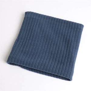 Detail of dark blue ribbed knit neck warmer showing soft elastic texture and stitch pattern