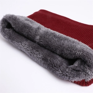 Close-up of wine red knitted neck warmer featuring thick dark grey plush lining texture