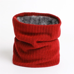 Detail of red knitted winter neck warmer with thick plush faux fur lining for wind protection
