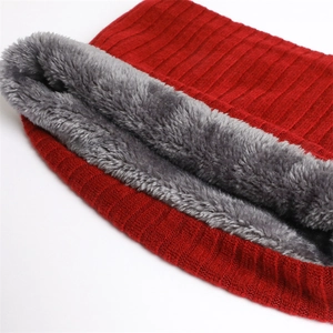 Detail of red ribbed knit neck warmer featuring thick grey faux fur lining and texture