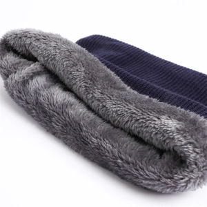 Detailed view of dark blue ribbed knit fabric with thick gray fleece lining for warmth