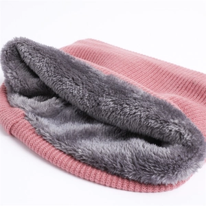 Close-up of pink knitted fabric with thick grey plush lining for winter neck warmer