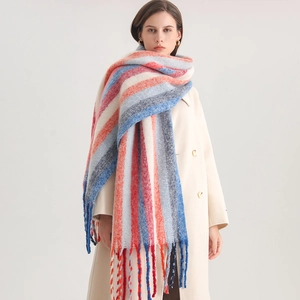 Detail of soft cashmere-like rainbow striped scarf with long tassel finish