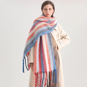 Detailed view of the thick plush fabric texture and long tassels of the striped scarf