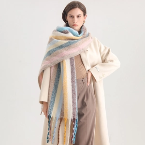 Detail of colorful rainbow striped scarf with soft texture and decorative tassels