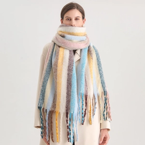 Close-up of thick winter knit scarf with colorful rainbow stripes and long tassels
