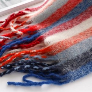 Close-up of fluffy rainbow striped scarf with soft fringe texture and vibrant yarns