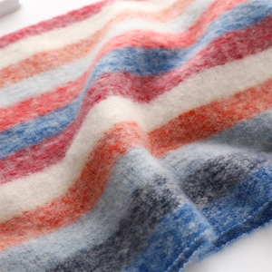 Macro detail of rainbow striped cashmere-like scarf showing soft plush texture and knit pattern