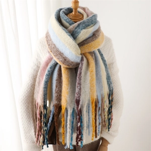 Rainbow striped pashmina scarf with long tassels shown on a wooden mannequin