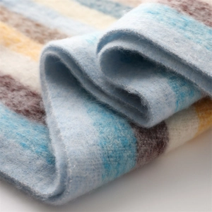 Close-up of soft rainbow striped cashmere-like scarf showing warm texture and plush fabric