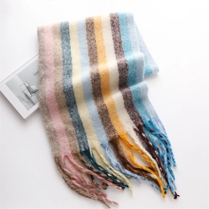 Detailed close-up of rainbow striped scarf showing soft cashmere-like texture and long fringe
