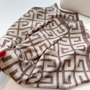 Detailed close-up of brown and beige geometric pattern on soft twill silk scarf