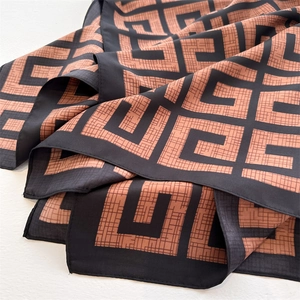 Detailed view of the soft silk-like texture and geometric pattern of the women scarf