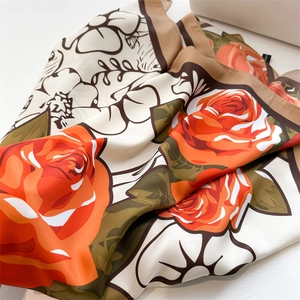 Detailed close-up of vintage rose print on smooth silk-like fabric scarf texture