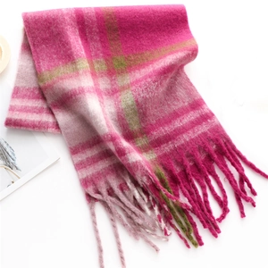 Close-up of thick pink plaid cashmere-feel scarf with long fringes for winter warmth